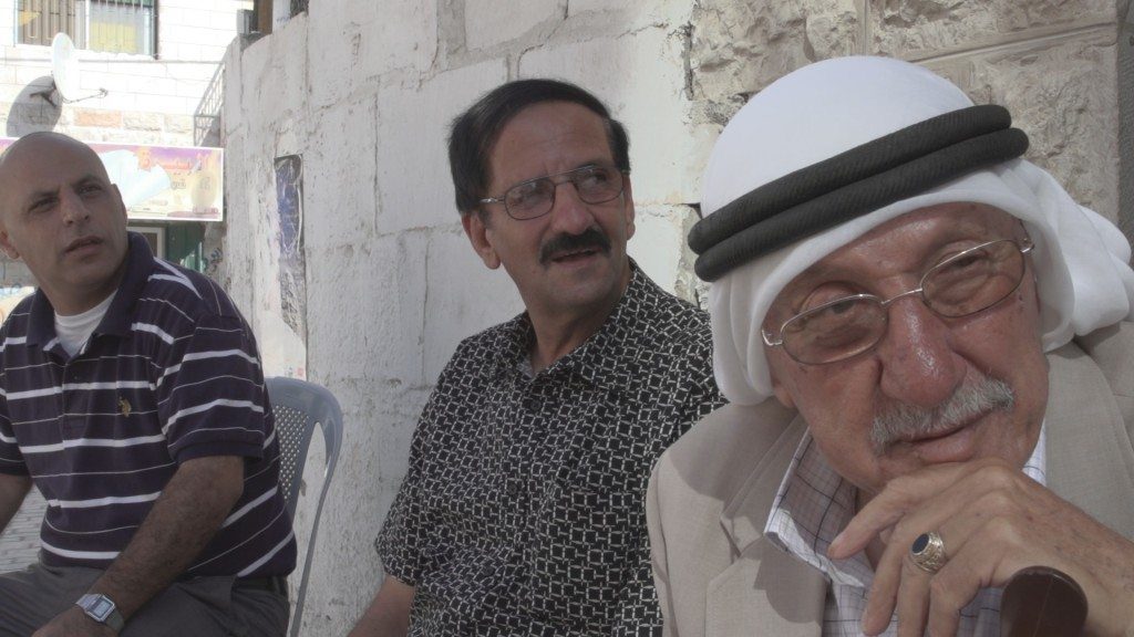 Three_Arab_men_in_front_of_cafe_AlBirra_WestBank