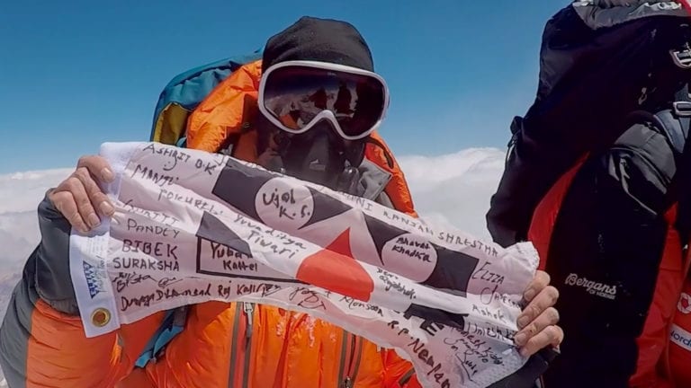 Chris on Summit with Save One Life Flag